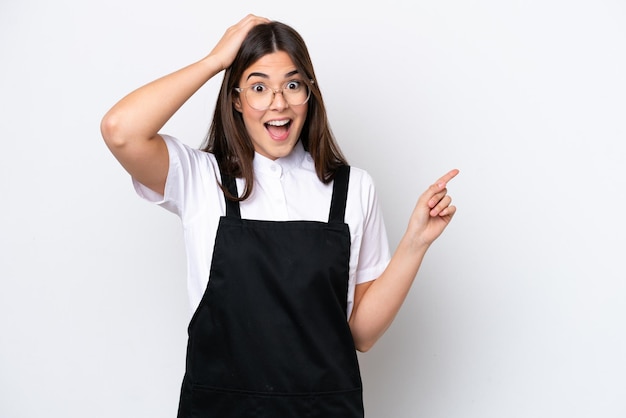 Restaurant Brazilian waiter woman isolated on white background surprised and pointing finger to the side