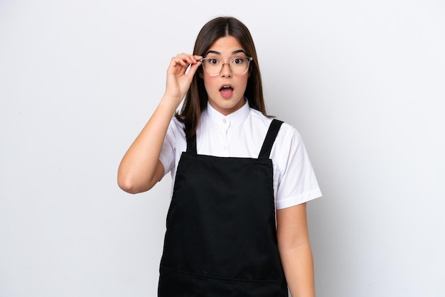 Restaurant brazilian waiter woman isolated on white background with glasses and surprised