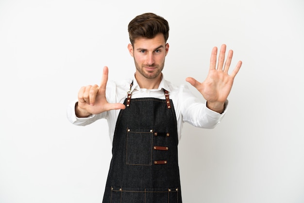 Restaurant caucasian waiter isolated on white background counting seven with fingers