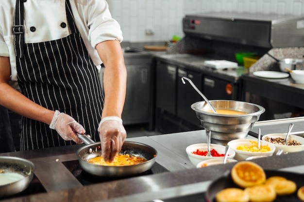 Restaurant cooks preparing food in the kitchen