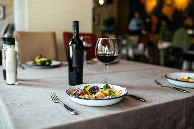 Restaurant dish served on the table with red wine