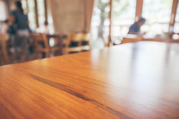 顧客と木製のテーブルとレストランのインテリアは、ボケ光で抽象的な背景をぼかします