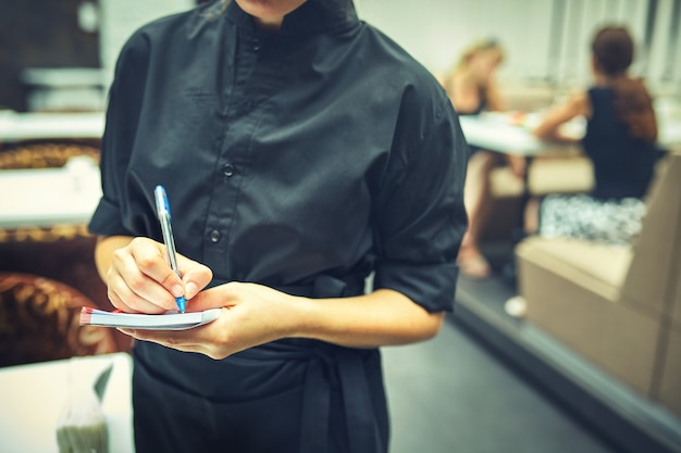 Restaurant manager woman at work place .