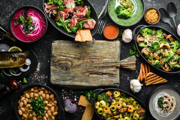 Restaurant menu Set of food and dishes on black stone background Top view