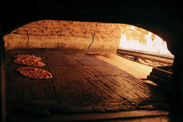 In a restaurant, pita or pide bread cooking in oven or stove. Bakery or bakehouse concept image.