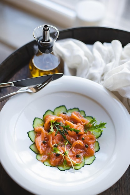 Restaurant serving of salmon on a substrate of vegetables