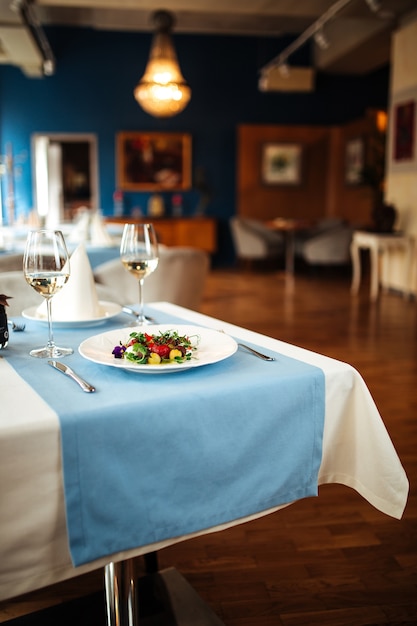 Restaurant table served with spanish peeled tomato salad