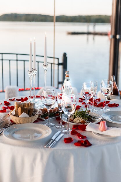 restaurant terras versierd en tafel geserveerd met bloemen en kaarsen voor romantisch huwelijk diner