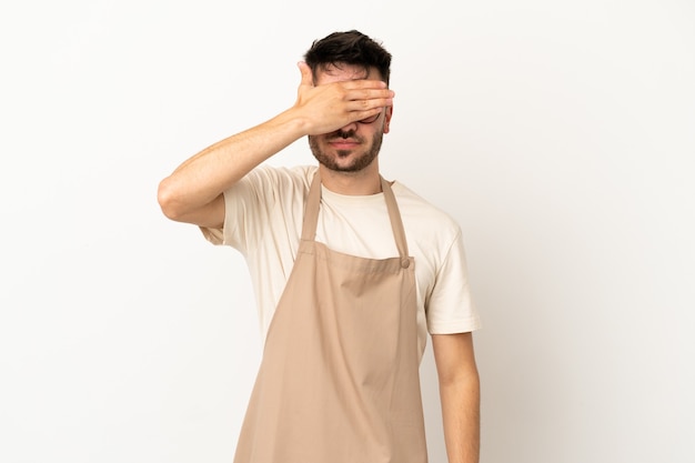 Restaurant waiter caucasian man isolated on white background covering eyes by hands. Do not want to see something