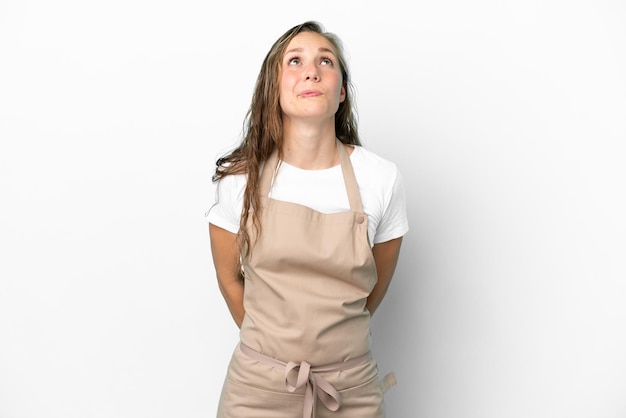 Restaurant waiter caucasian woman isolated on white background and looking up