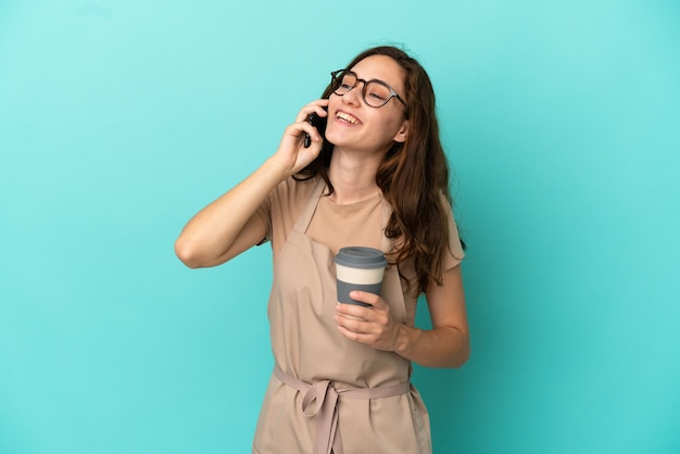 Restaurant waiter holding coffee to take away and a mobile