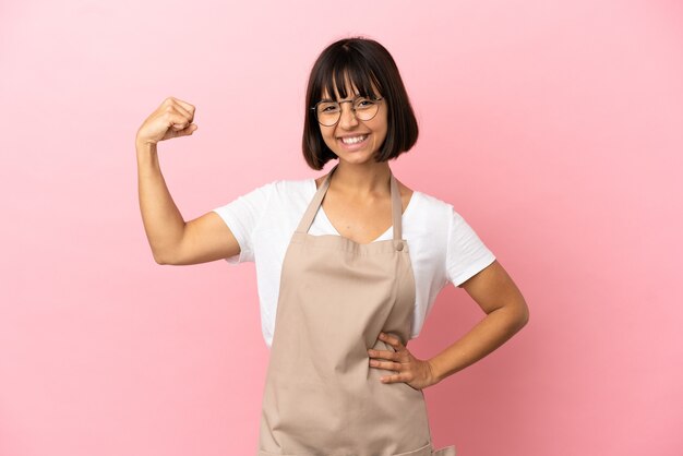 Restaurant waiter over isolated pink background doing strong gesture