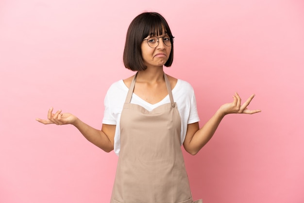 Restaurant waiter over isolated pink background happy and smiling