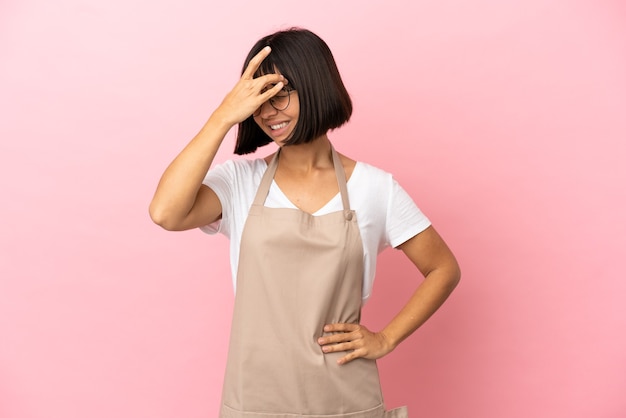 Restaurant waiter over isolated pink background with headache