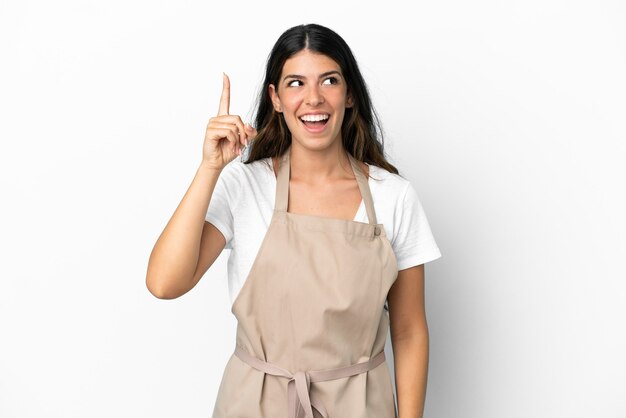 restaurant waiter over isolated white background intending to realizes the solution while lifting a finger up