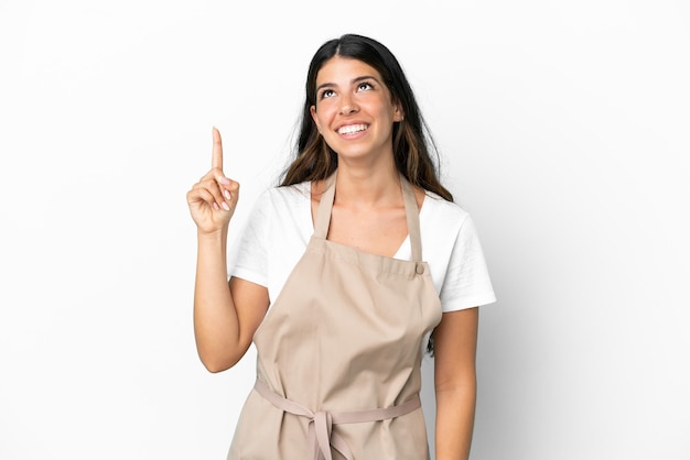 restaurant waiter over isolated white background pointing up and surprised
