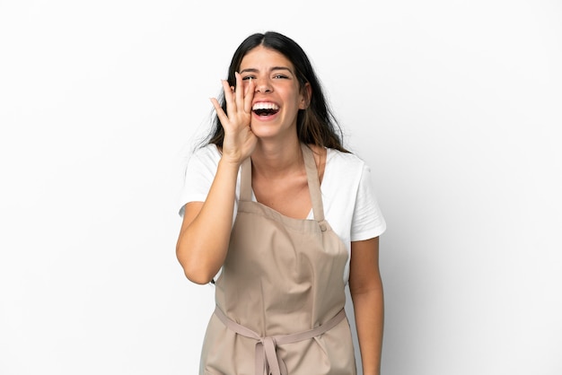 Restaurant waiter over isolated white background shouting with mouth wide open