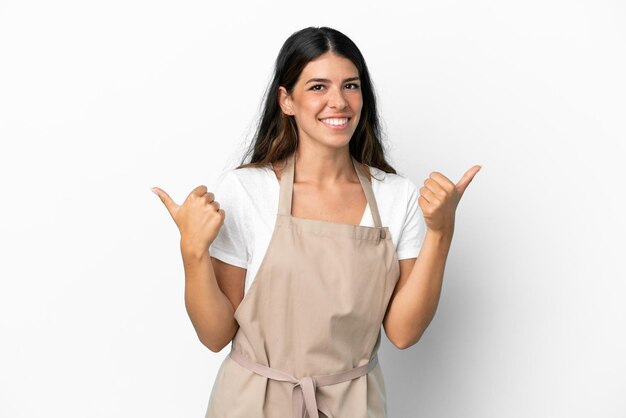 Restaurant waiter over isolated white background with thumbs up gesture and smiling