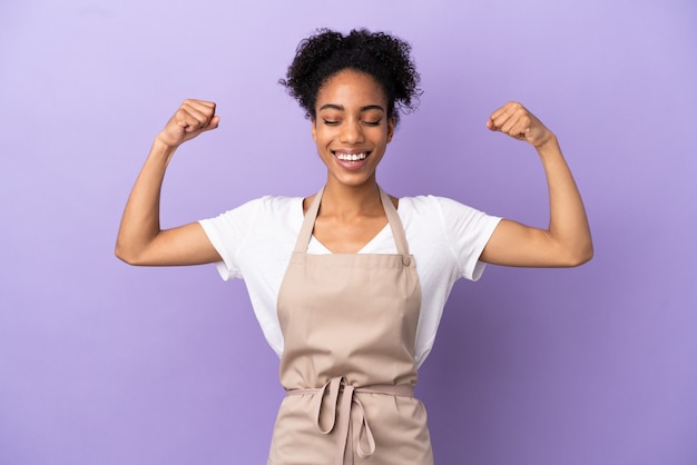 Restaurant waiter latin woman isolated on purple background doing strong gesture