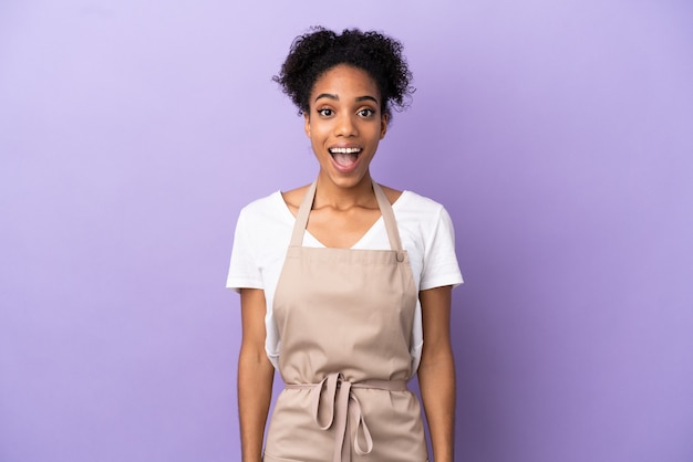 Restaurant waiter latin woman isolated on purple background with surprise facial expression