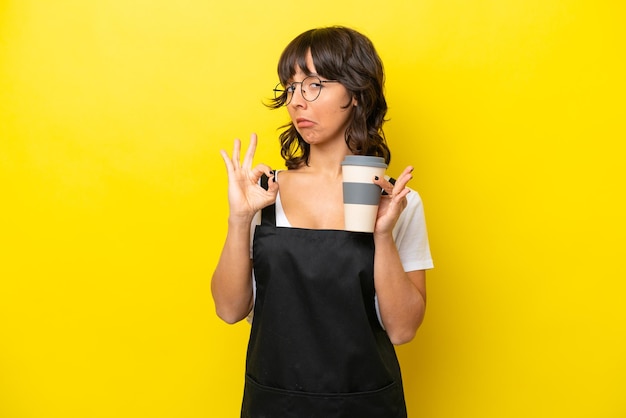 Restaurant waiter latin woman isolated on yellow bakcground