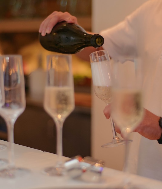 A restaurant waiter serving champagne