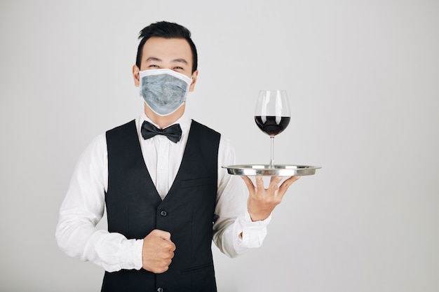 Restaurant waiter serving wine