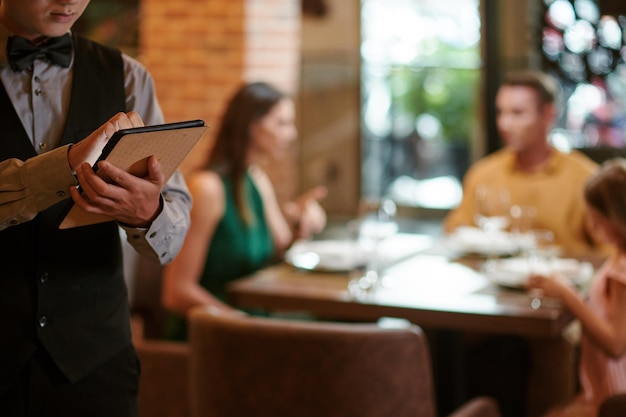 Restaurant Waiter Writing Order Details