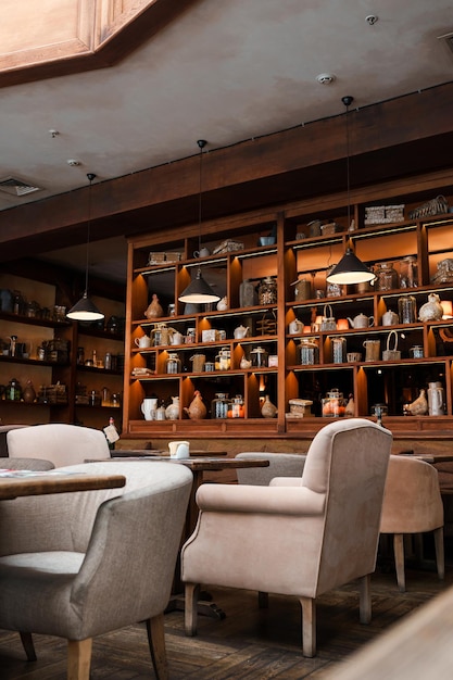 A restaurant with a large shelf full of pottery