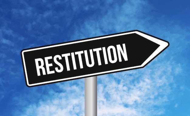 Restitution road sign on blue sky background