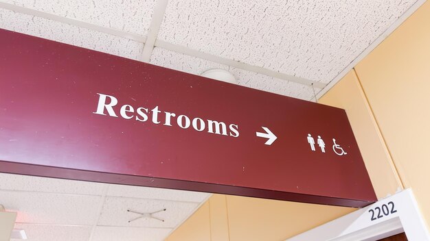 restroom sign depicting gender icons of a woman and a man symbolizing social issues surrounding gen