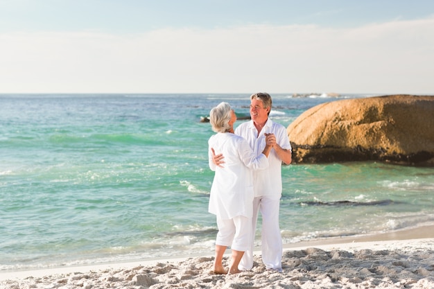 Retired couple dancing on the beach