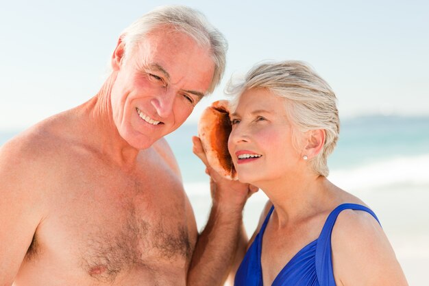 Retired couple listening to their shell