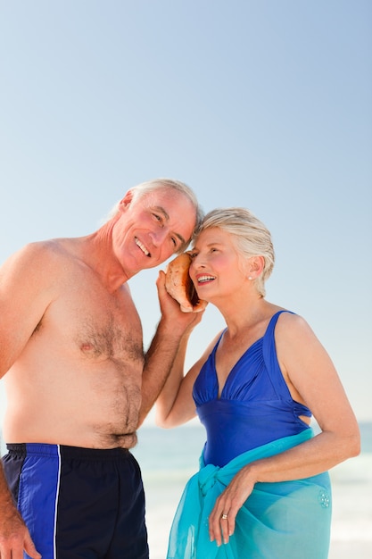 Retired couple listening to their shell