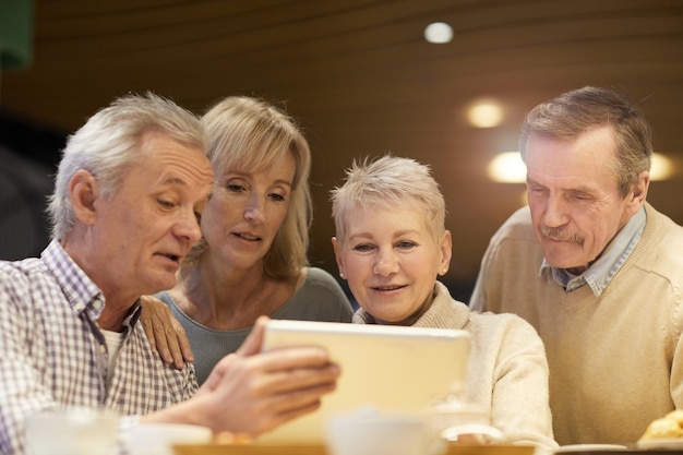 Retired friends watching video online