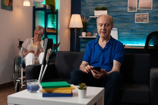 Retired happy caucasian couple relaxed in living room