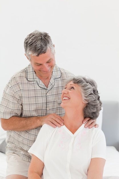 Retired man giving a massage to his wife