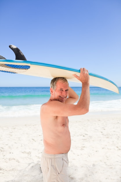 Retired man with his surfboard