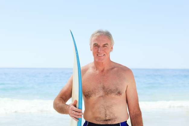 Retired  man with his surfboard