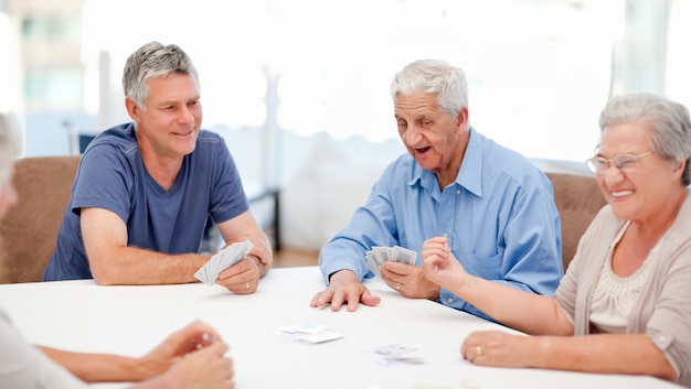 Retired people playing cards together