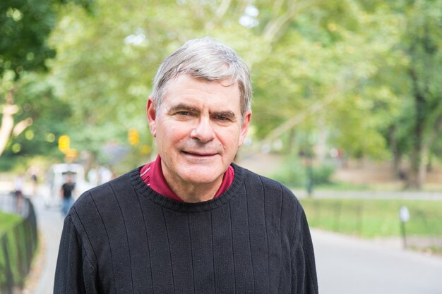 Retired Senior Man at Park, Walking and Relaxing, Smiling Expression