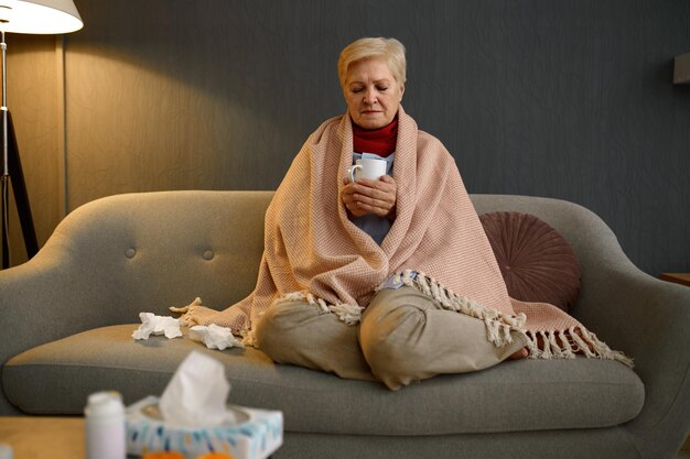 Retired woman caught cold drinking tea portrait