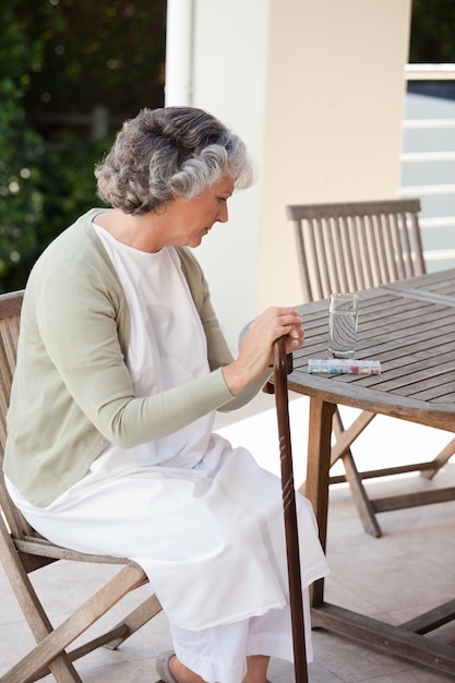 Retired woman with her walking stick