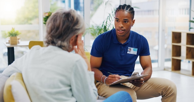 retirement documents and a nurse talking to an old woman patient about healthcare in an assisted living facility medical planning and communication with a black man consulting a senior in her home