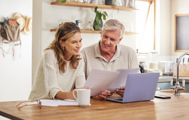 Retirement finance and couple with budget on laptop satisfied with home expenses in New Zealand Happy positive and married senior people checking financial documents for investment payment