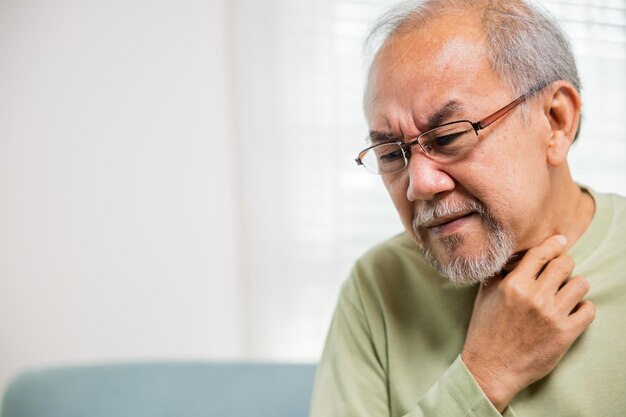 Retirement senior man feeling pain use hands holding neck and irritation in throat