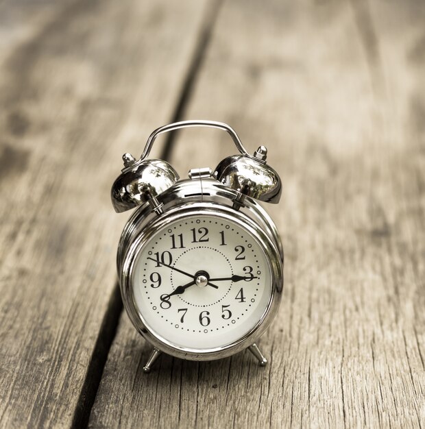 Retro alarm clock on old wood table