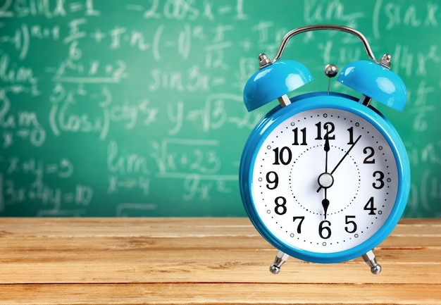 Retro alarm clock on table  background