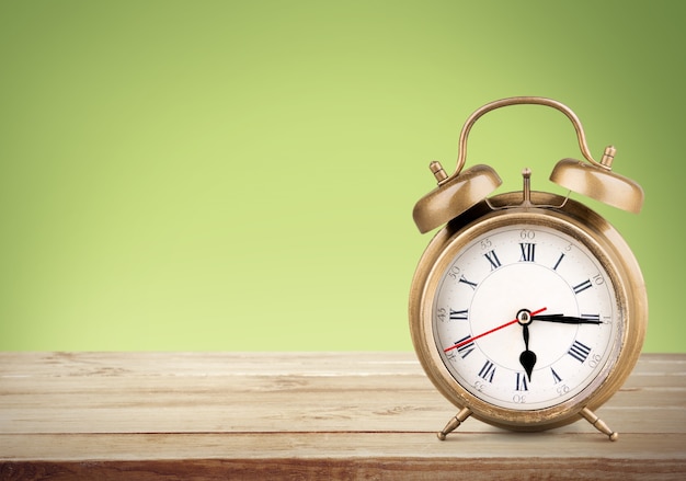 Retro alarm clock on table  background