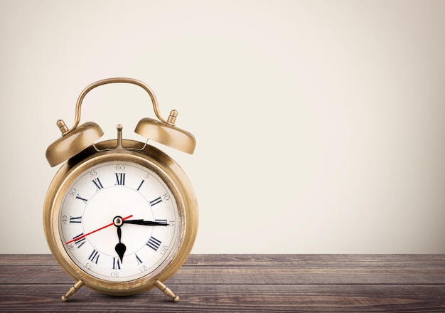 Retro alarm clock on table  background